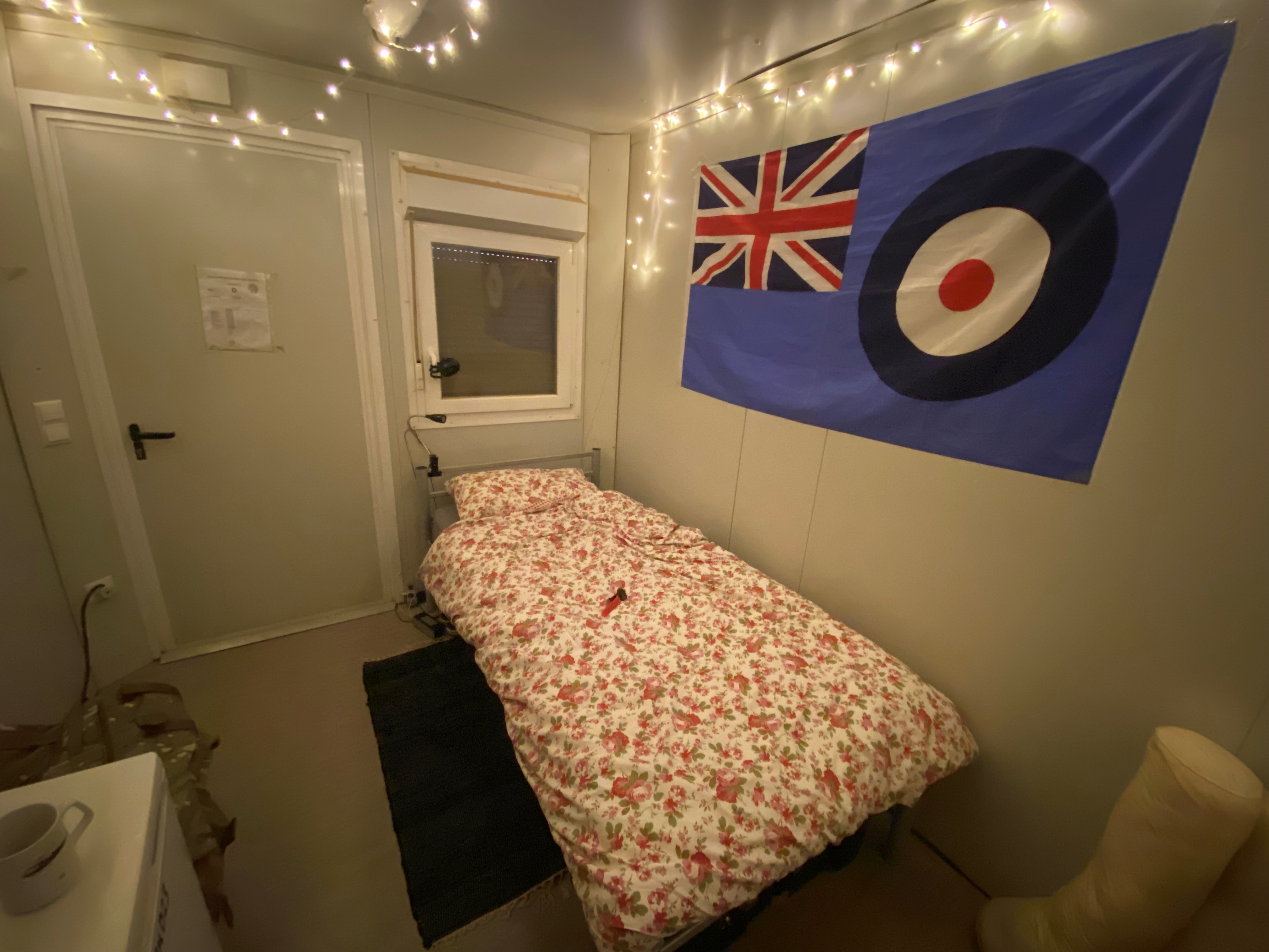Bed quarters and RAF flag hanging on the wall. 